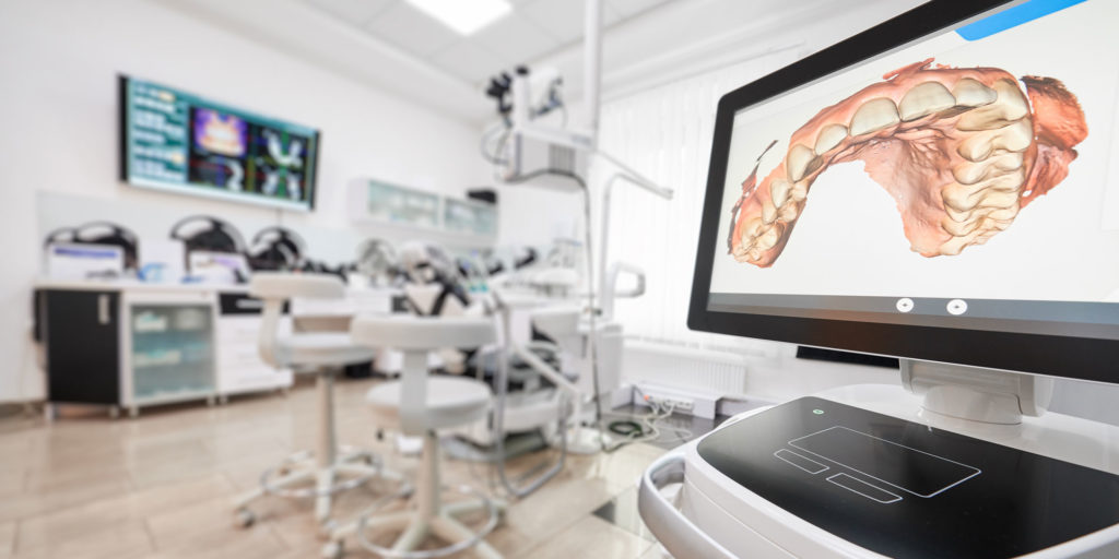 dental office with 3d model of teeth on screen